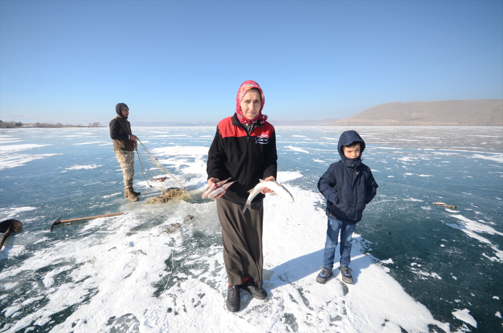 Eskimo usulü balık avlayan kadın, ekmeğini buzun altından çıkartıyor